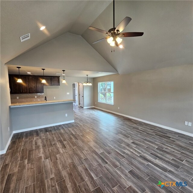 unfurnished living room featuring ceiling fan, high vaulted ceiling, and dark hardwood / wood-style flooring