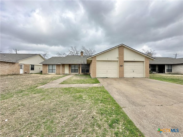 ranch-style house featuring a garage and a front lawn