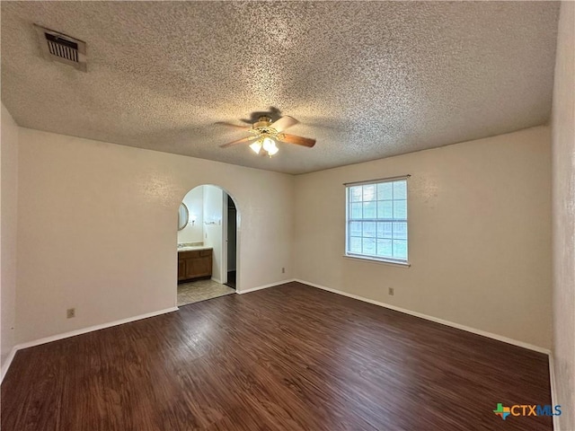 spare room featuring hardwood / wood-style floors, a textured ceiling, and ceiling fan