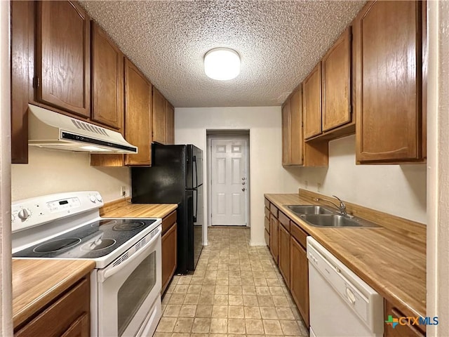 kitchen with sink, white appliances, and a textured ceiling