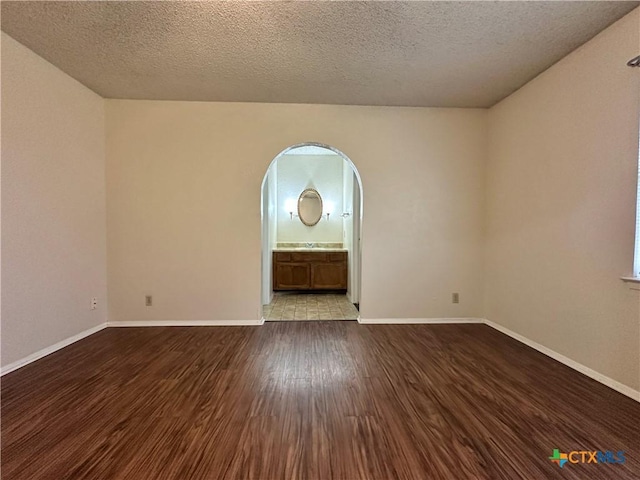 empty room featuring light hardwood / wood-style flooring and a textured ceiling