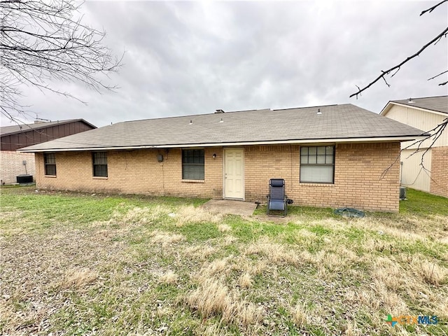 rear view of property with a lawn