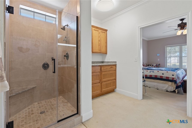 bathroom with vanity, ceiling fan, an enclosed shower, and crown molding