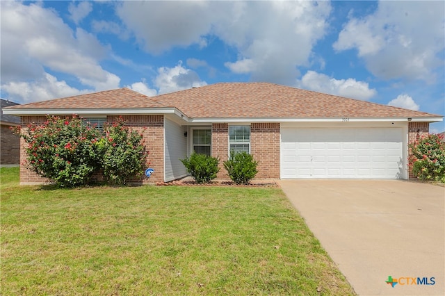 ranch-style home with a garage and a front yard