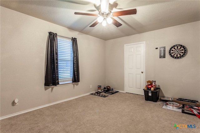 misc room with carpet floors and ceiling fan