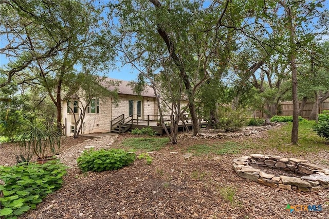 123 E Sierra Cir, San Marcos, TX 78666 - view of yard featuring an outdoor fire pit and a deck
