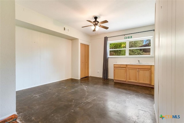 123 E Sierra Cir, San Marcos, TX 78666 - unfurnished room featuring ceiling fan, finished concrete floors, and wooden walls