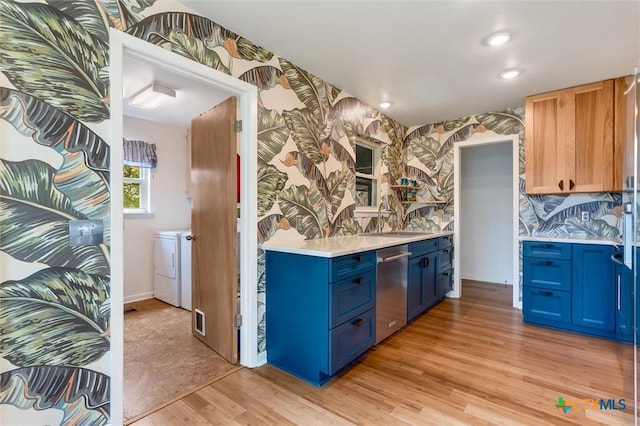 123 E Sierra Cir, San Marcos, TX 78666 - kitchen with blue cabinets, dishwasher, light wood-style flooring, light countertops, and washing machine and dryer