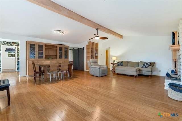 123 E Sierra Cir, San Marcos, TX 78666 - dining room featuring a barn door, light wood-type flooring, and a ceiling fan