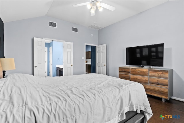 bedroom featuring dark hardwood / wood-style flooring, connected bathroom, vaulted ceiling, and ceiling fan