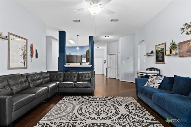 living room with ceiling fan and dark wood-type flooring