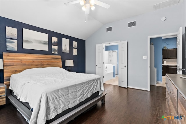 bedroom featuring vaulted ceiling, ensuite bath, ceiling fan, and dark hardwood / wood-style floors