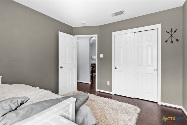 bedroom featuring dark hardwood / wood-style flooring and a closet