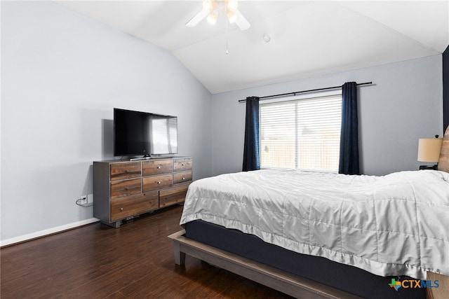 bedroom with ceiling fan, dark wood-type flooring, and lofted ceiling