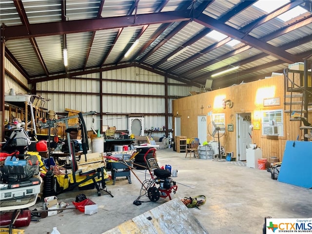 garage with wood walls and a workshop area