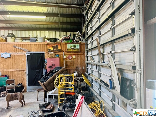 garage featuring wooden walls