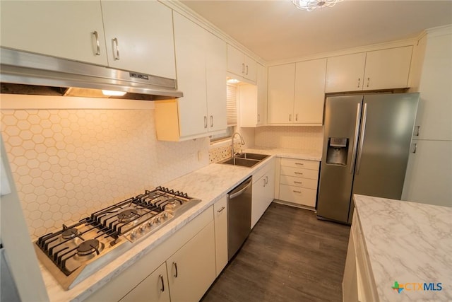 3001 Hummingbird St, Victoria, TX 77901 - kitchen featuring stainless steel appliances, under cabinet range hood, dark wood finished floors, white cabinets, and tasteful backsplash