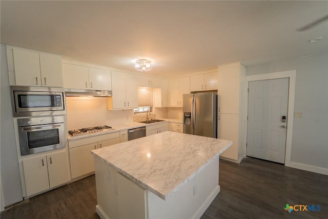 3001 Hummingbird St, Victoria, TX 77901 - kitchen with appliances with stainless steel finishes, light countertops, dark wood-type flooring, and white cabinetry