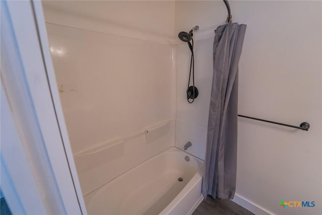 3001 Hummingbird St, Victoria, TX 77901 - full bathroom featuring shower / bath combo with shower curtain and wood finished floors