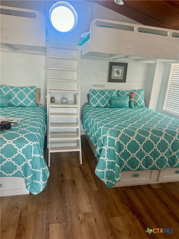 bedroom featuring hardwood / wood-style floors and vaulted ceiling