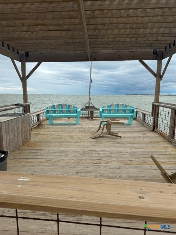 wooden terrace featuring a water view