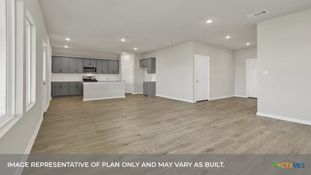 unfurnished living room with light hardwood / wood-style flooring