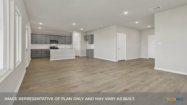 620 Radley Rd, Lockhart, TX 78644 - unfurnished living room featuring recessed lighting, baseboards, and light wood-type flooring