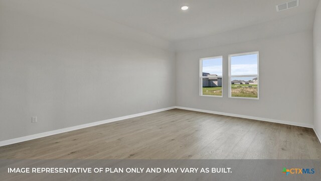 empty room with light hardwood / wood-style flooring