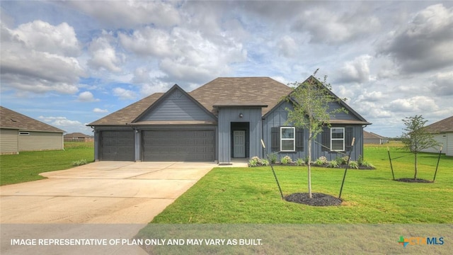 620 Radley Rd, Lockhart, TX 78644 - view of front facade with board and batten siding, a front yard, an attached garage, and concrete driveway