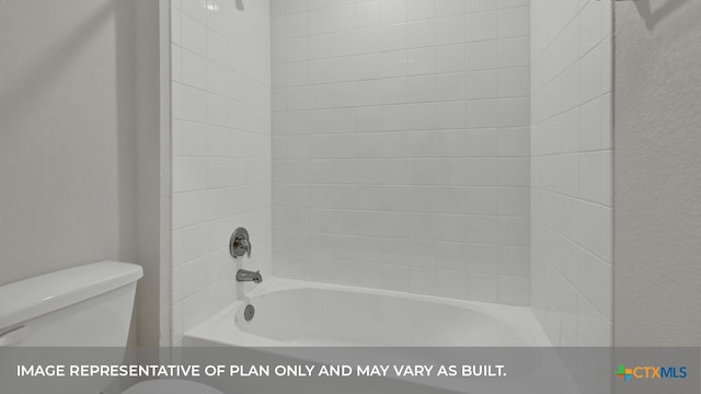 bathroom featuring toilet and tiled shower / bath combo