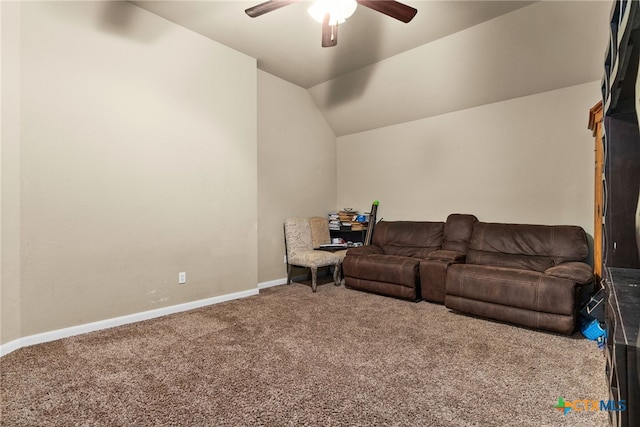 carpeted living room featuring baseboards, lofted ceiling, and a ceiling fan