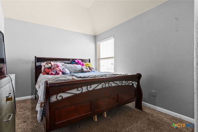 bedroom with vaulted ceiling, carpet, baseboards, and a textured wall