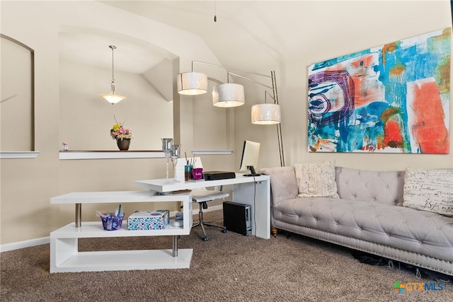 carpeted home office featuring baseboards and vaulted ceiling