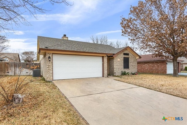 single story home with brick siding, driveway, an attached garage, and fence