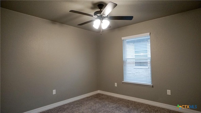 carpeted spare room featuring ceiling fan