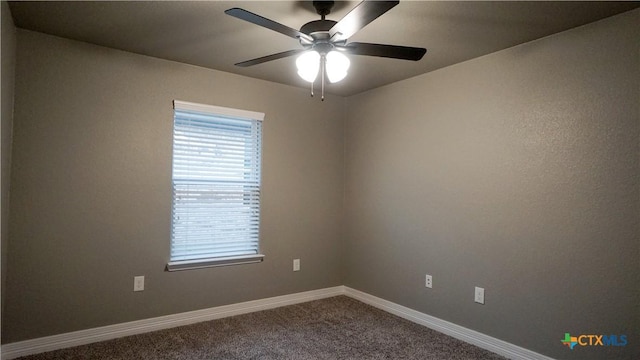 spare room with ceiling fan and carpet