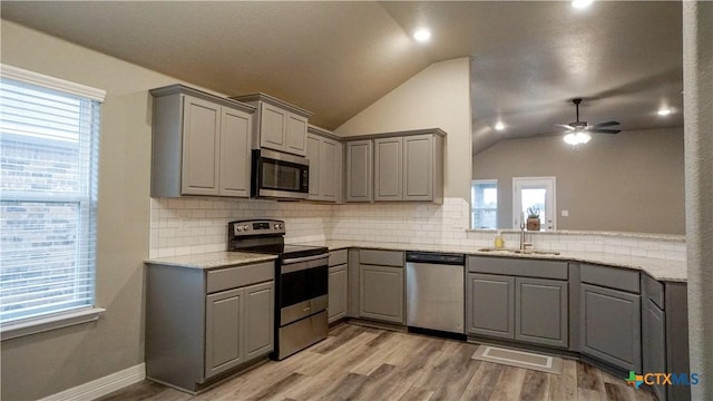 kitchen featuring stainless steel appliances, gray cabinets, and sink