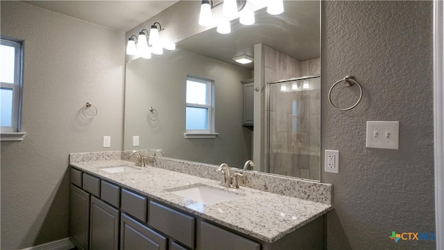 bathroom featuring vanity and an enclosed shower