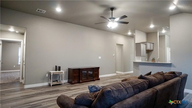 living room featuring hardwood / wood-style flooring and ceiling fan