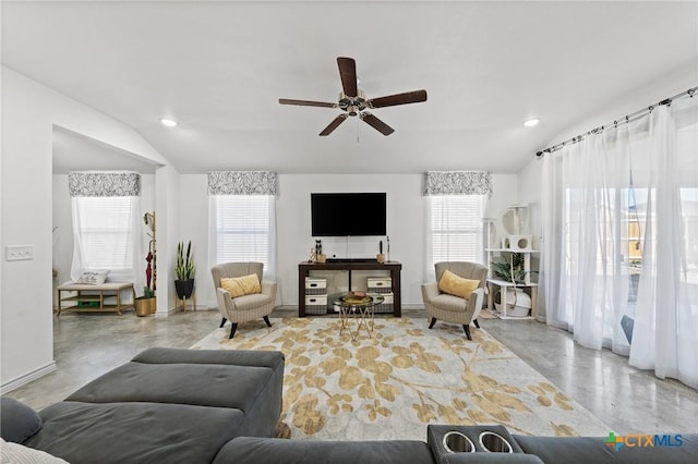 living room featuring ceiling fan, lofted ceiling, and plenty of natural light