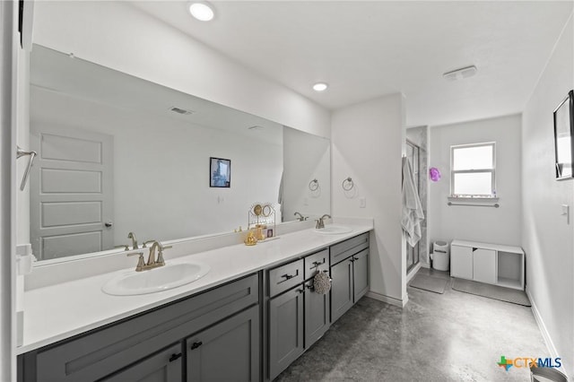 bathroom featuring a shower with door, vanity, and concrete flooring