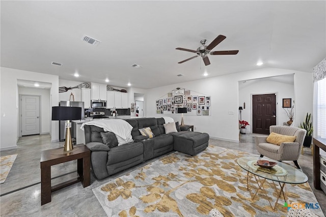 living room featuring ceiling fan and vaulted ceiling