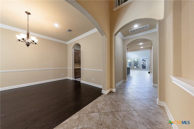 26815 Tulip Mdw, Boerne, TX 78015 - empty room featuring ornamental molding, tile patterned floors, and a chandelier