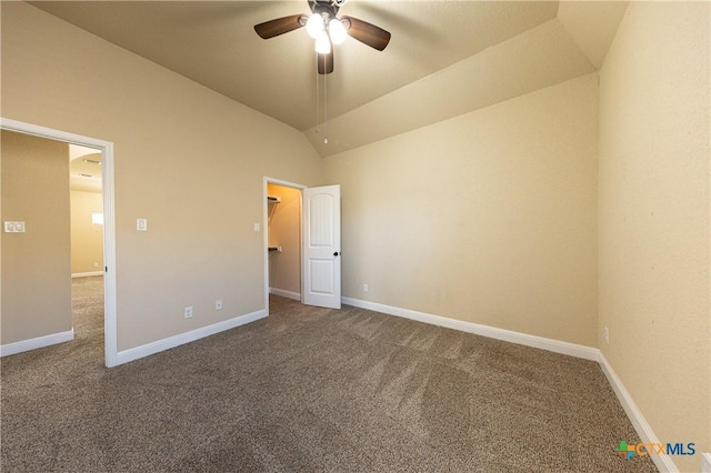 26815 Tulip Mdw, Boerne, TX 78015 - unfurnished bedroom featuring carpet, a spacious closet, vaulted ceiling, and ceiling fan