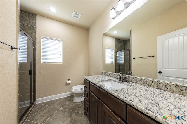 26815 Tulip Mdw, Boerne, TX 78015 - bathroom with vanity, a shower stall, plenty of natural light, and a textured wall