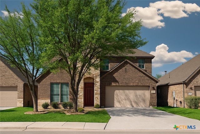 26815 Tulip Mdw, Boerne, TX 78015 - traditional-style house featuring concrete driveway, a garage, a front yard, brick siding, and stone siding