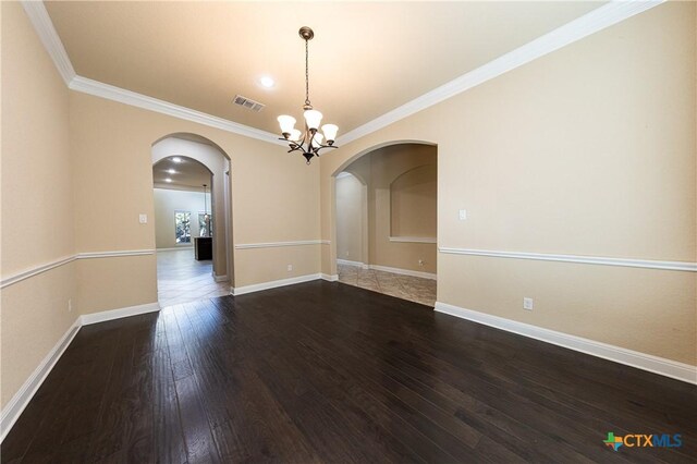 26815 Tulip Mdw, Boerne, TX 78015 - spare room with arched walkways, dark wood finished floors, crown molding, and a chandelier