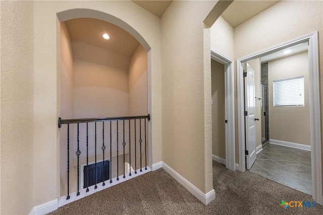 26815 Tulip Mdw, Boerne, TX 78015 - corridor featuring carpet, arched walkways, recessed lighting, and a textured wall