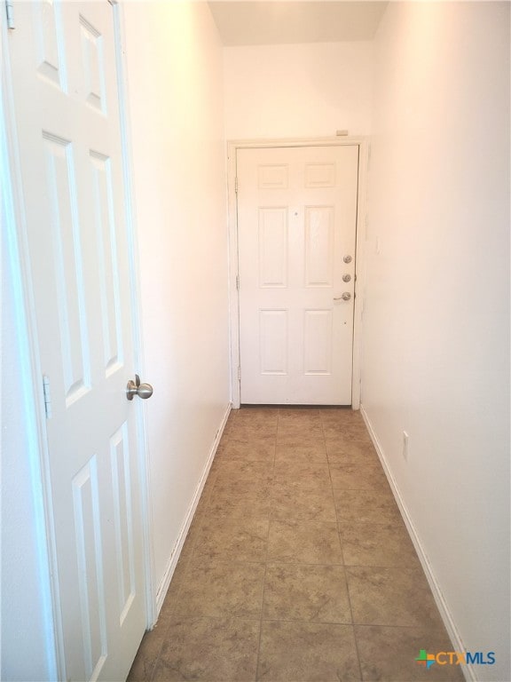 hall with light tile patterned floors