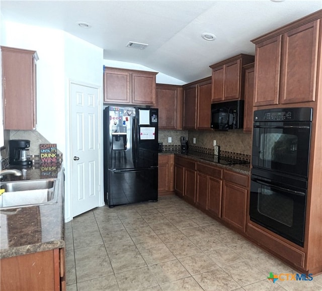 kitchen with light tile patterned flooring, sink, black appliances, decorative backsplash, and vaulted ceiling